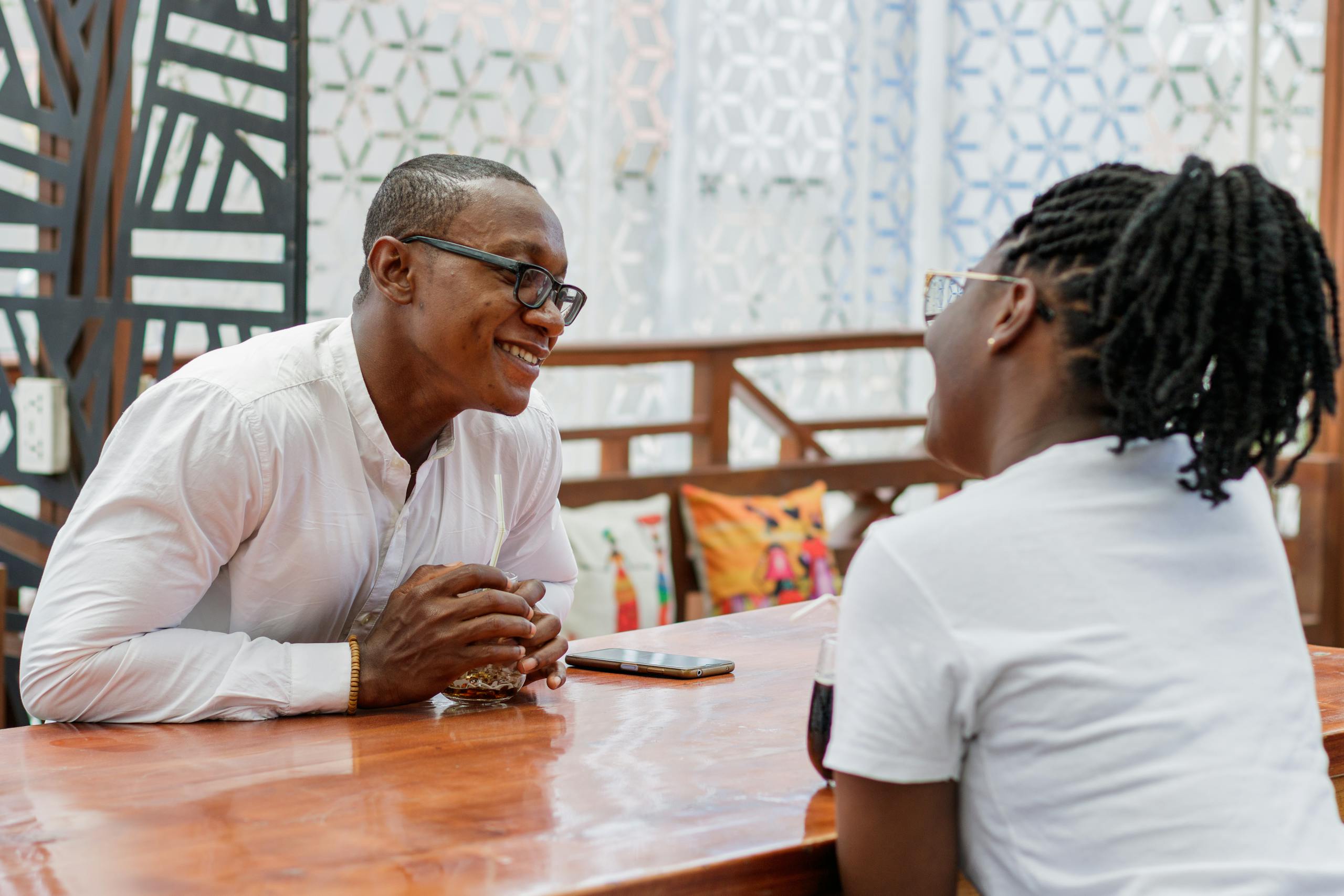 A joyful couple engaging in a heartfelt conversation at a vibrant restaurant.