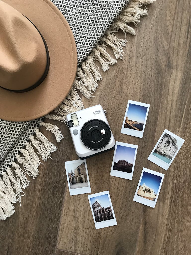 A vintage instant camera with travel photos on a rustic wooden background, capturing memories and adventure.
