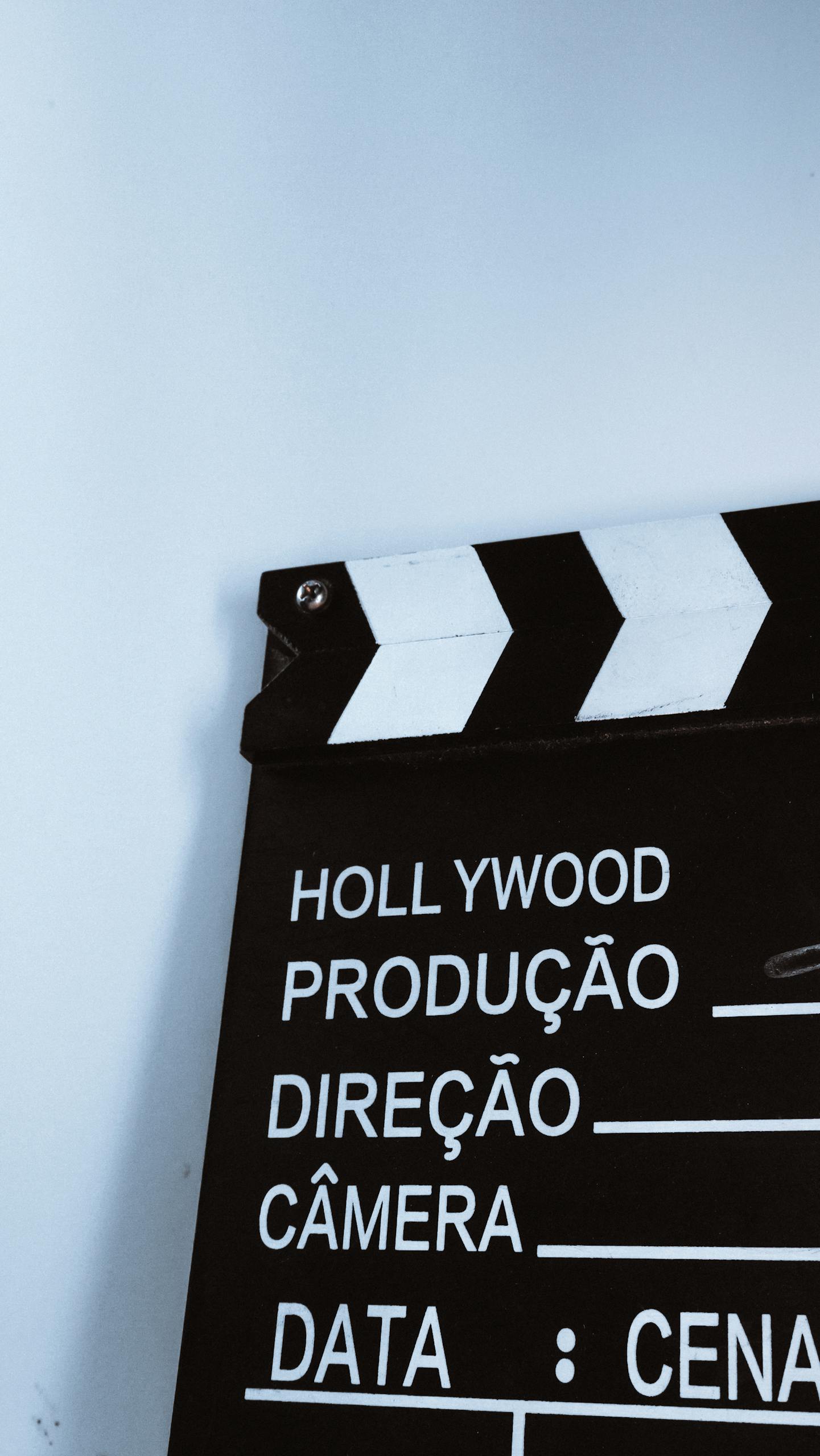 Close-up vertical shot of a clapperboard with text, ideal for film and media themes.