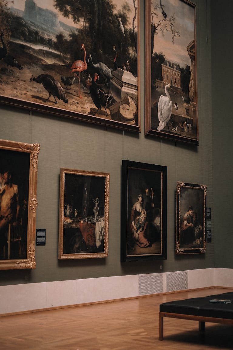 Elegant art gallery interior with classic paintings on green walls in Munich, Germany.