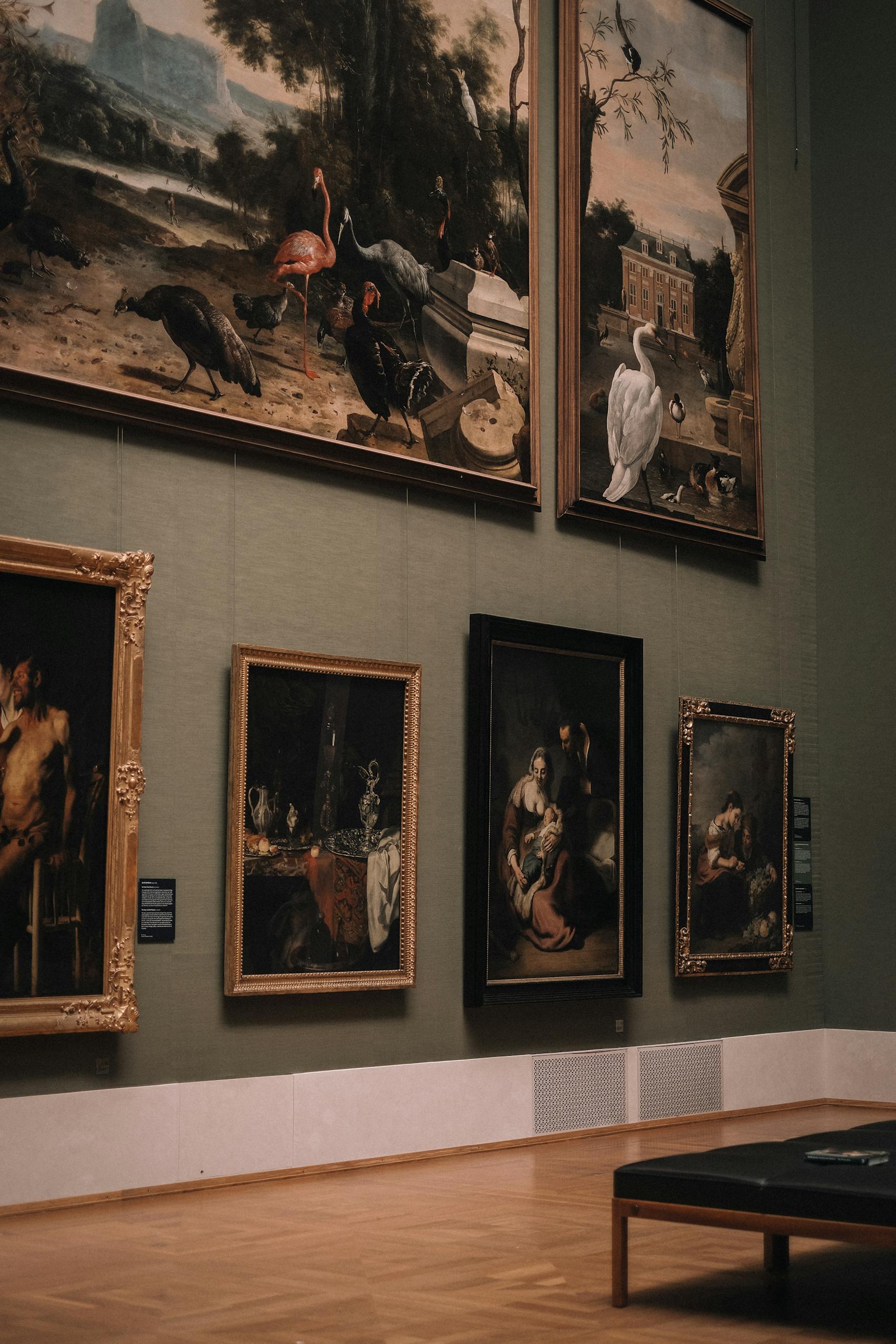 Elegant art gallery interior with classic paintings on green walls in Munich, Germany.