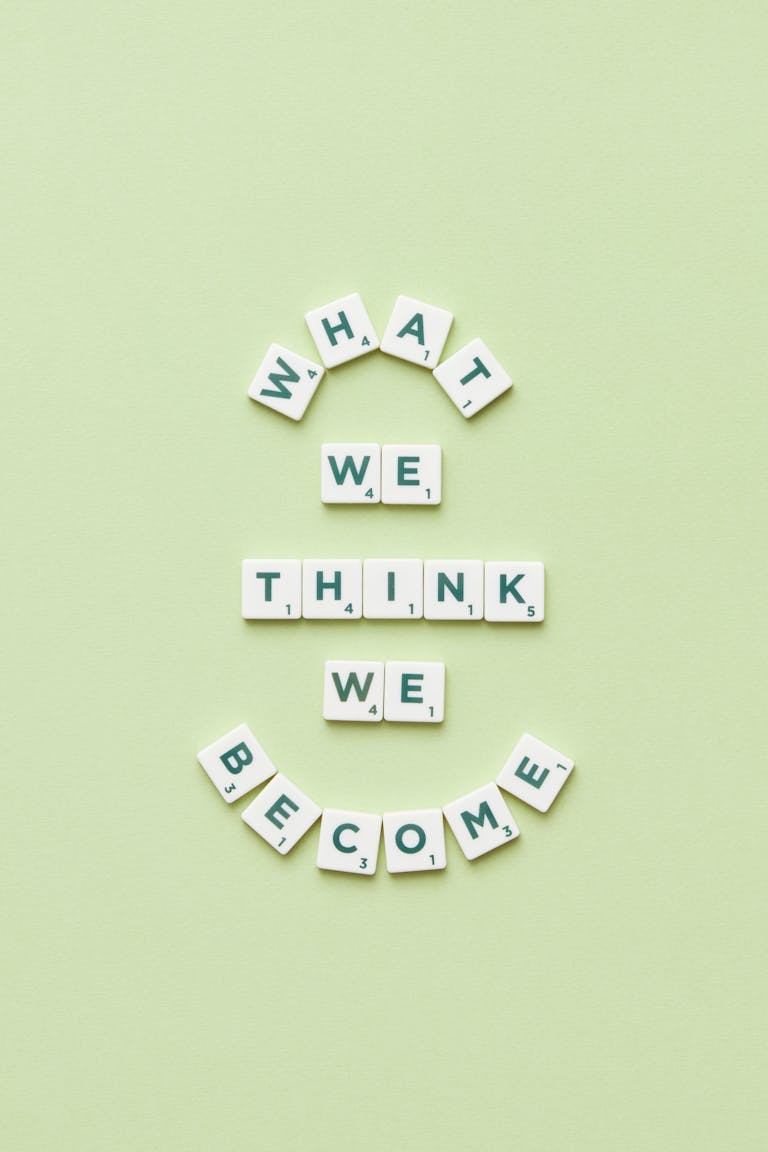 Motivational quote arranged with letter tiles on a light green background.