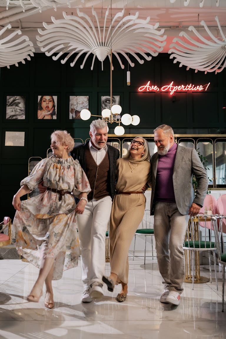 Senior adults dancing joyfully together indoors, capturing a lively moment of friendship.