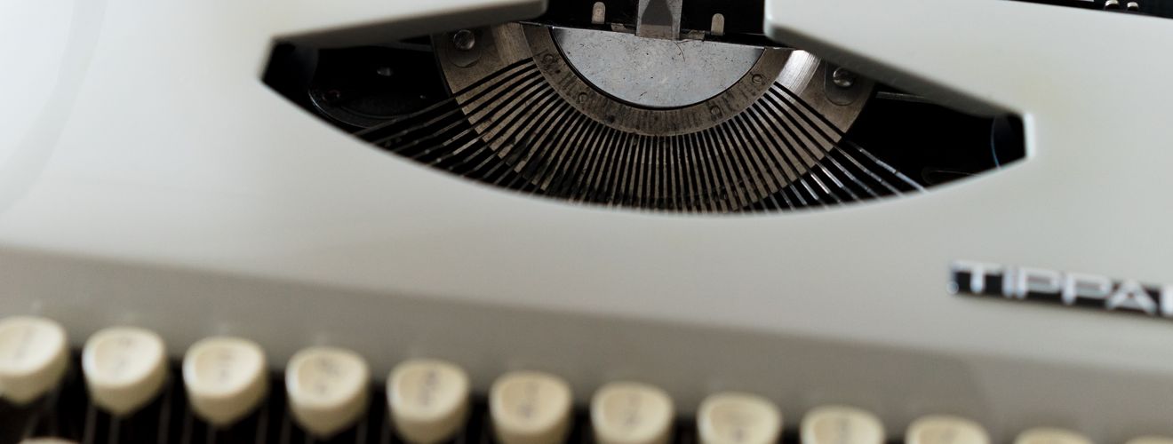 A close-up of a typewriter showcasing 'ARTIFICIAL INTELLIGENCE' on paper.