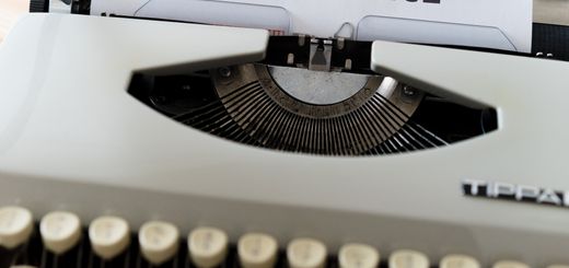 A close-up of a typewriter showcasing 'ARTIFICIAL INTELLIGENCE' on paper.