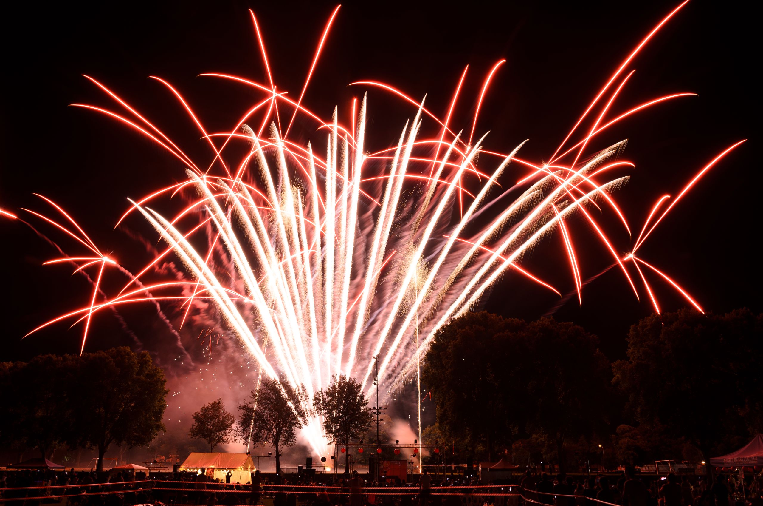 A dazzling fireworks display lights up the night sky during a celebration outdoors.