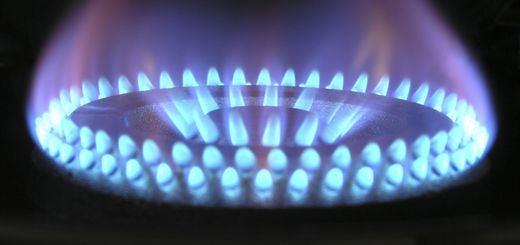 A detailed view of a blue flame on a gas stove, illustrating heat and warmth.