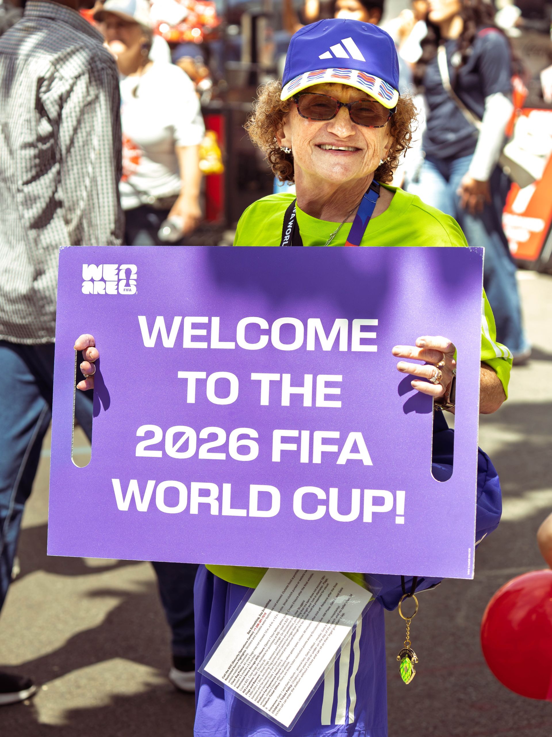 A person holds a sign welcoming the 2026 FIFA World Cup in Seattle.