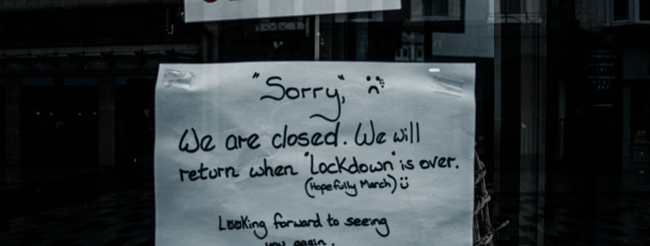 A shop window in Darlington, England displays a closed sign due to lockdown.