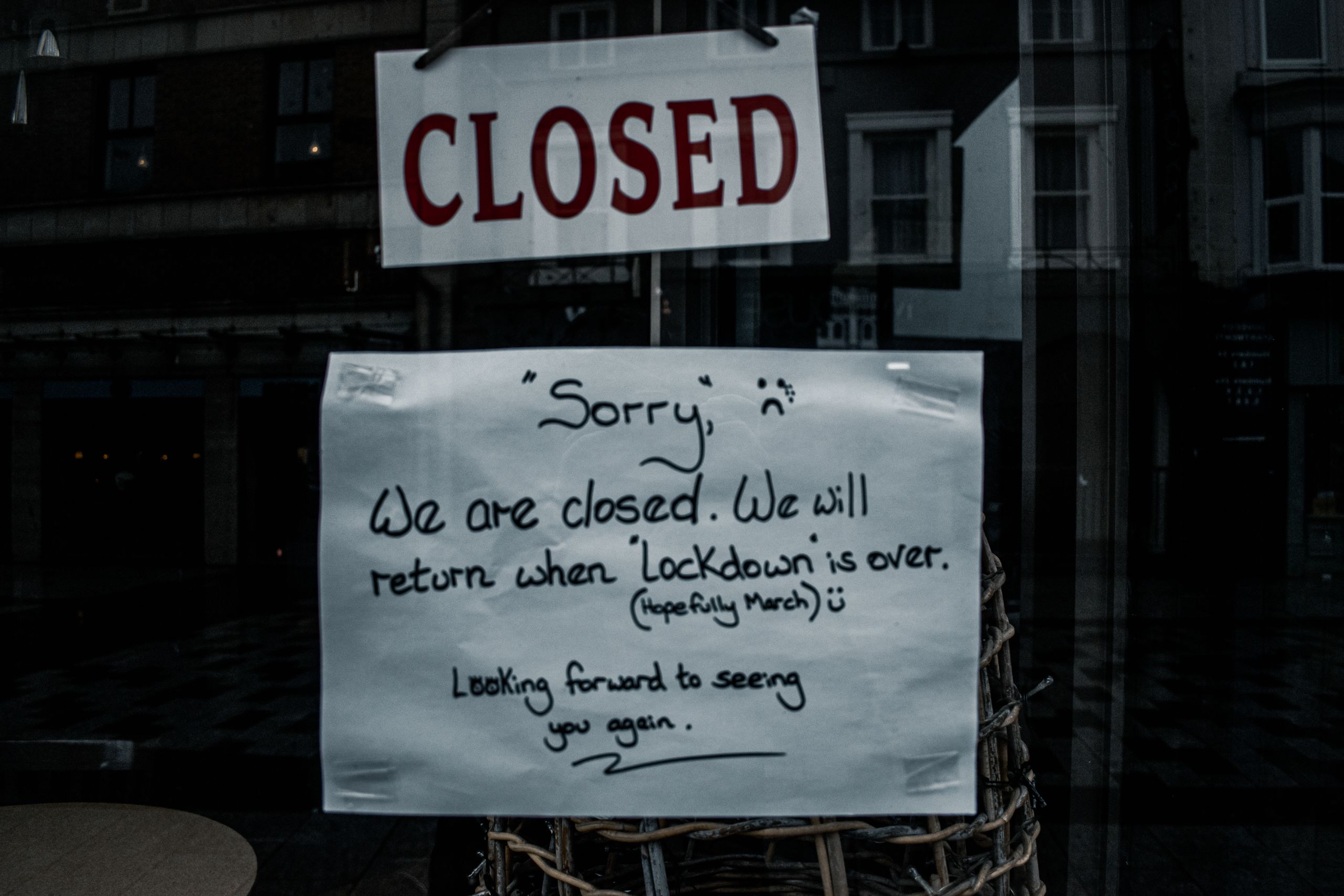 A shop window in Darlington, England displays a closed sign due to lockdown.