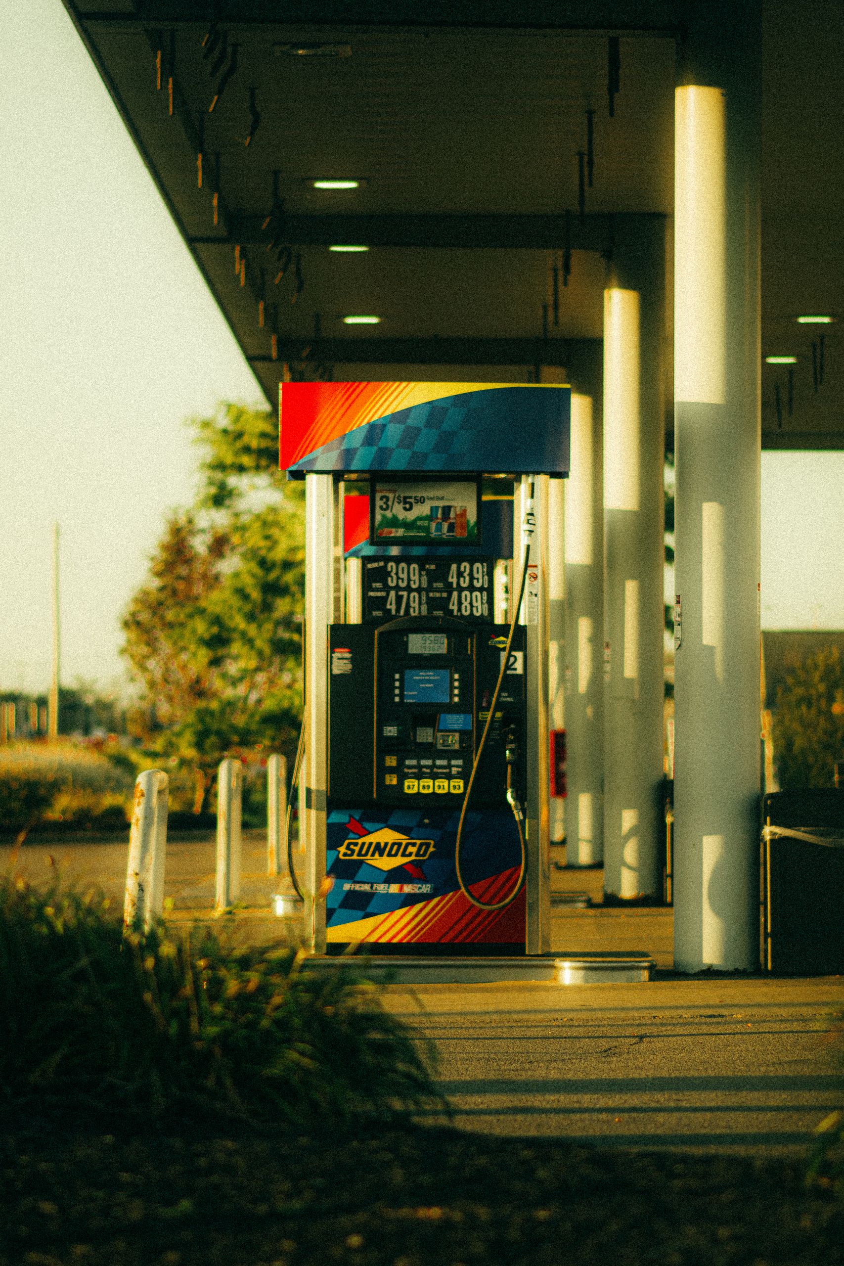 A vibrant Sunoco gas station pump captured at sunset with warm lighting and modern design.