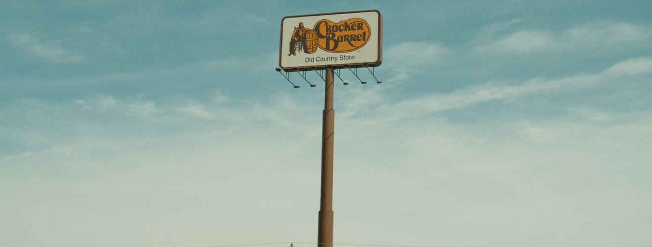 Cracker Barrel signpost with a clear blue sky background in Valdosta, GA, USA.