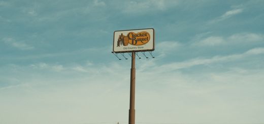 Cracker Barrel signpost with a clear blue sky background in Valdosta, GA, USA.