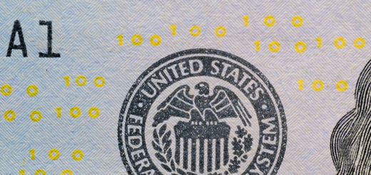 Detailed view of the US Federal Reserve System seal on currency with yellow digital numbers.