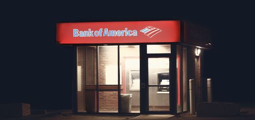 Illuminated Bank of America ATM structure against a dark nighttime backdrop in Boston.