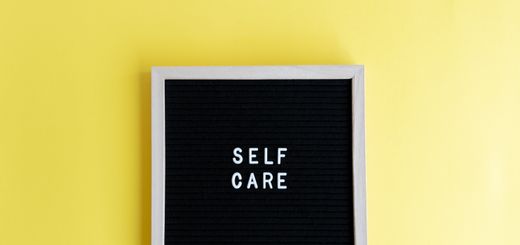 Inspiring self care message on a blackboard with a vibrant yellow background.