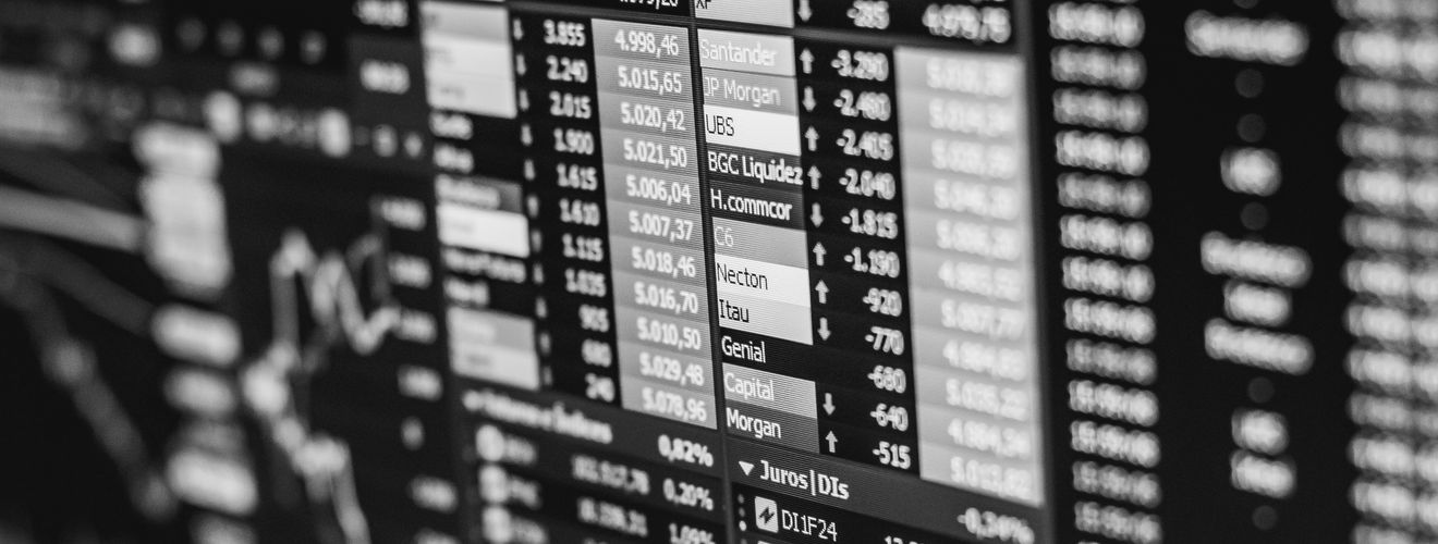 Monochrome image of stock market data on a screen, depicting financial information and trends.