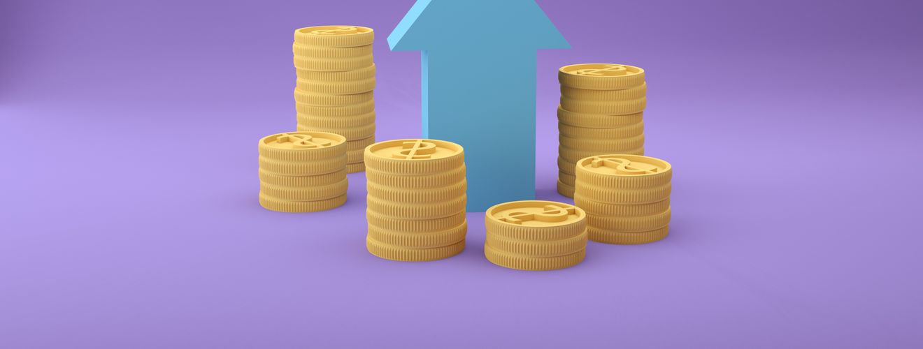 Stacks of coins with an upward arrow symbolizing financial growth and success.