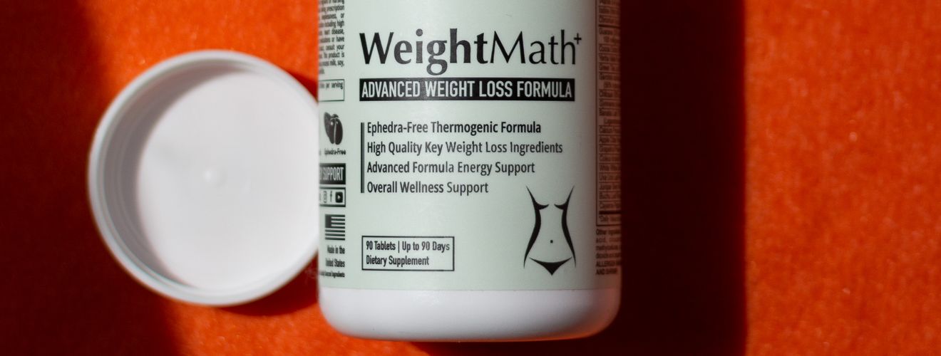 WeightMath supplement bottle with capsules, providing digestive health and weight loss support.